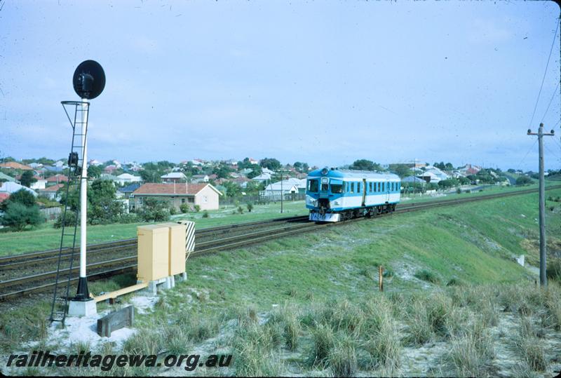 T03858
ADX class 670, Nanking blue and light grey livery, stainless steel cowcatcher, single car, rear of searchlight signal, relay boxes, lineside telephone box,  Bayswater, ER line, view along the track.
