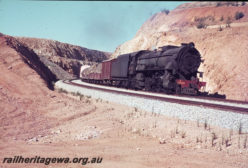 T04469
V class 1203 steam locomotive pictured at the head of No. 24 goods train departing Windmill hill cutting in the Avon Valley.
