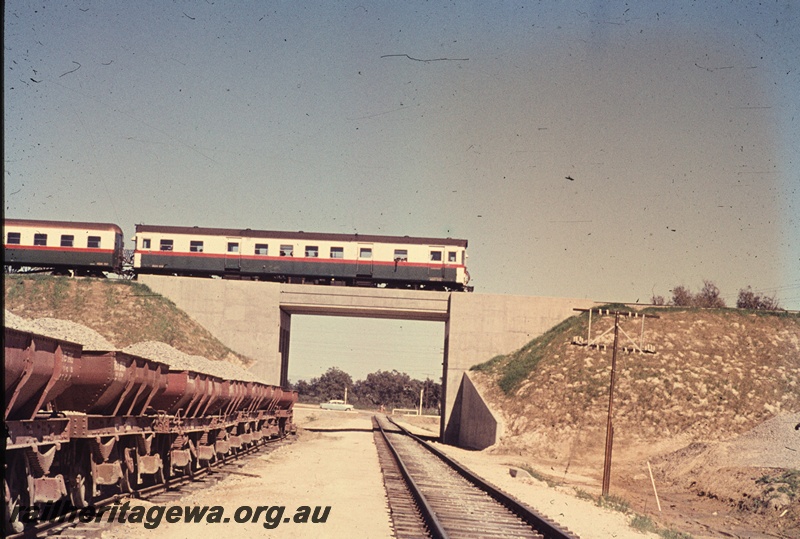T04563
An unidentified ADG class railcar crossing the new standard gauge trackage at Kenwick. Standard gauge 4 wheel loaded ballast hoppers visible to the left.
