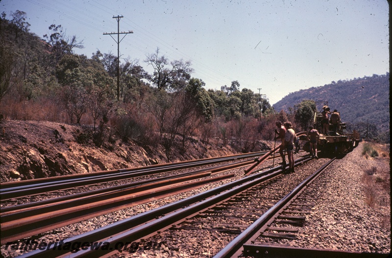 T04854
Track relaying,  workers dropping rails from flatcar , Avon Valley line, end view
