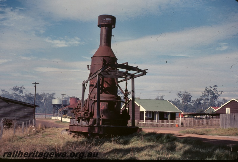 T04974
Abandoned steam winch, makers plate indicated made in Portland Oregon, houses, roads, water tower, cylindrical tank with a roof, Millars yard, Jardee, PP line 
