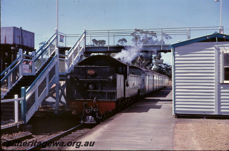 T05257
DD class 595 bunker first, on passenger train, water tower, 25,000 gallon cast iron tank, pedestrian footbridge, platform, station building, Armadale, SWR line
