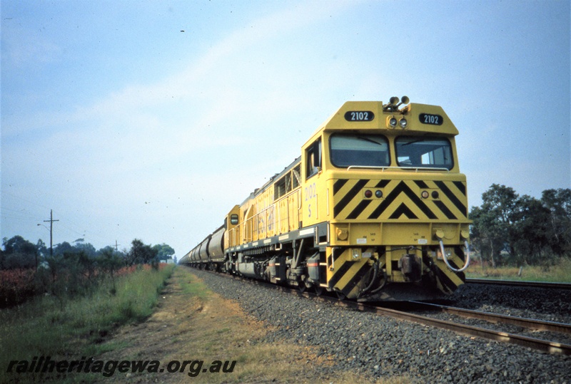 T05428
5 class 2102, on goods train, at Benger passing loop, SWR line, side and front view
