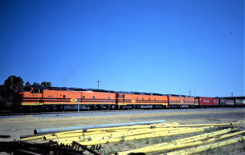 T05433
Australian Railroad Group CLP class 11, ALF class 18, CLF class 3, triple heading freight train, overhead bridge, pipes in foreground, front and side view
