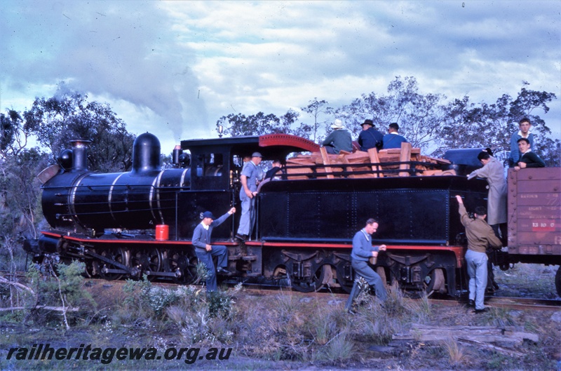 T05463
Bunnings YX class 86  locomotive, with timber filled tender, workers and spectators on the tender,  between the Donnelly River timber mill and the WAGR siding at Yornup, side and end view from trackside,  ARHS Outing,
