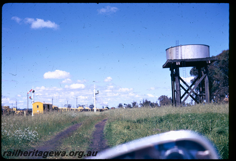 T06587
V Class 1209, goods train, arriving at Brunswick Junction, water tower with a squatters tank, semaphore signals, Z Class brakevan in yellow livery
