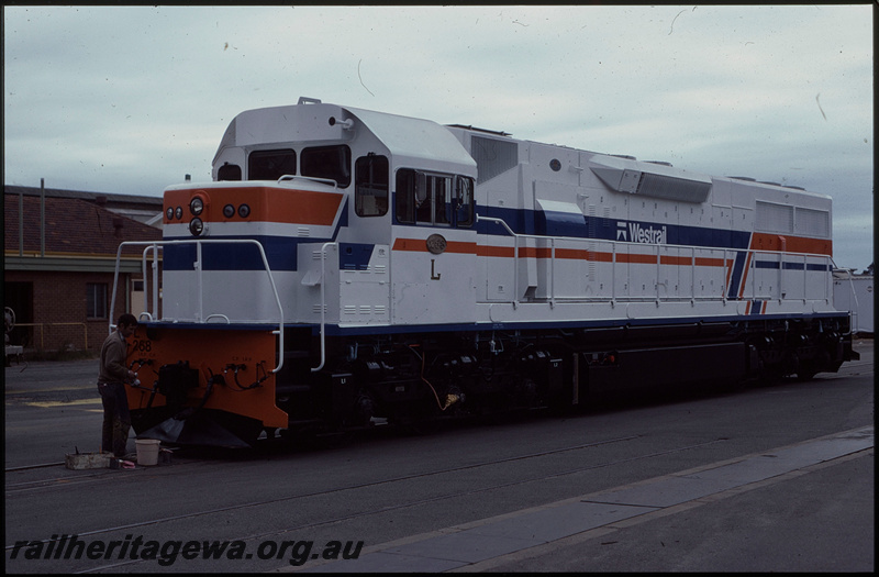 T07956
L Class 268, experimental white livery, fresh out of the paint shop, painter putting final touches on livery, Midland Workshops, ER line
