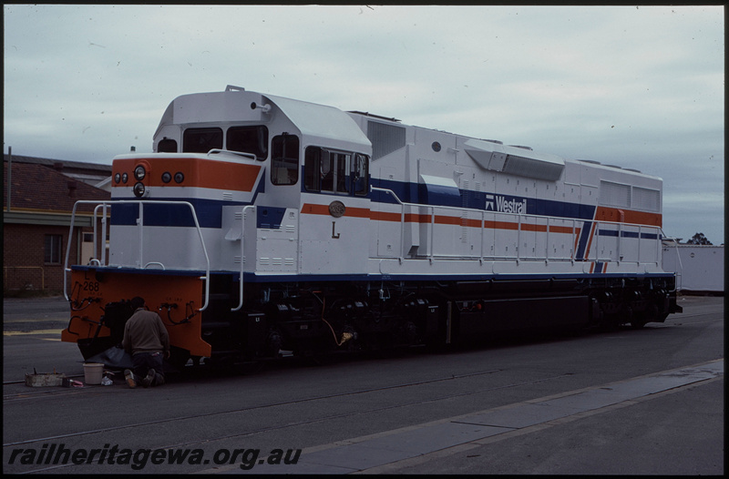 T07957
L Class 268, experimental white livery, fresh out of the paint shop, painter putting final touches on livery, Midland Workshops, ER line
