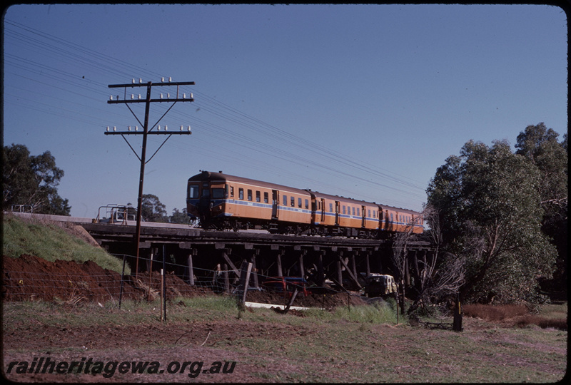 T08191
ADA/ADG/ADG Class railcar set, Down suburban passenger service, between Stokely and Gosnells, Canning River Bridge, timber trestle, new concrete bridge under construction behind trestle, SWR line
