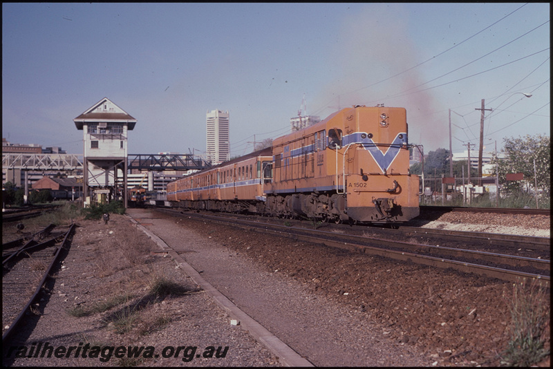 T08263
A Class 1502, Down suburban passenger service, departing Claisebrook, ADA Class trailers and de-engined ADX Class railcars in consist, signal cabin, footbridge, standard gauge headshunt for Perth Terminal on right, ER line
