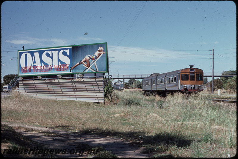 T08295
ADB Class 776 trailer with ADK Class railcar, Up suburban passenger service, between Cottesloe and Mosman Park, footbridge, billboard, ER line
