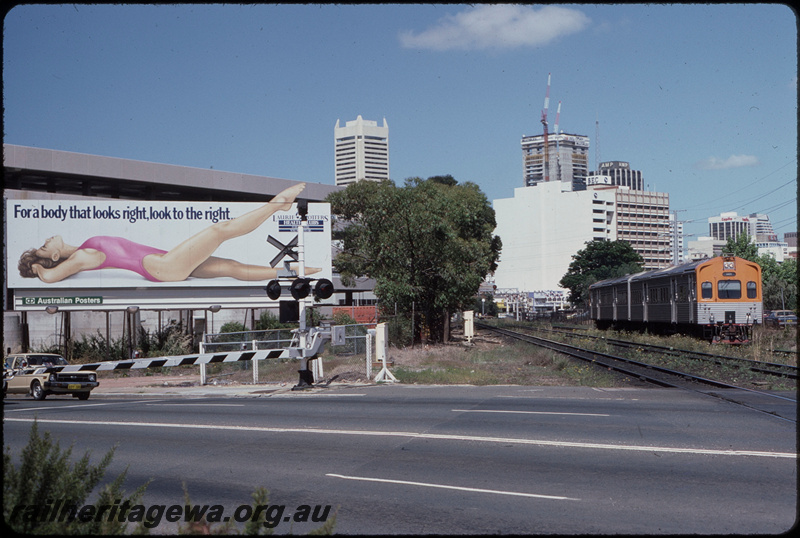T08300
ADC/ADL Class railcar set, Down suburban passenger sevice, between City and Claisebrook, Lord Street level crossing, billboard for Laurie Potters Healthclubs, ER line
