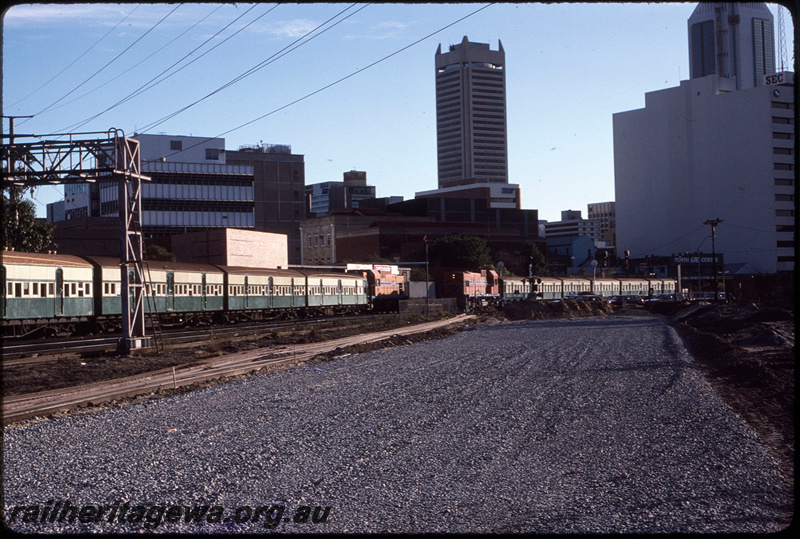 T08640
A Class 1510, Up suburban passenger service, unidentified AB Class, Down suburban passenger service, between Claisebrook and City Station, Moore Street level crossing, earthworks underway for construction of additional trackwork and McIver Station, ER line
